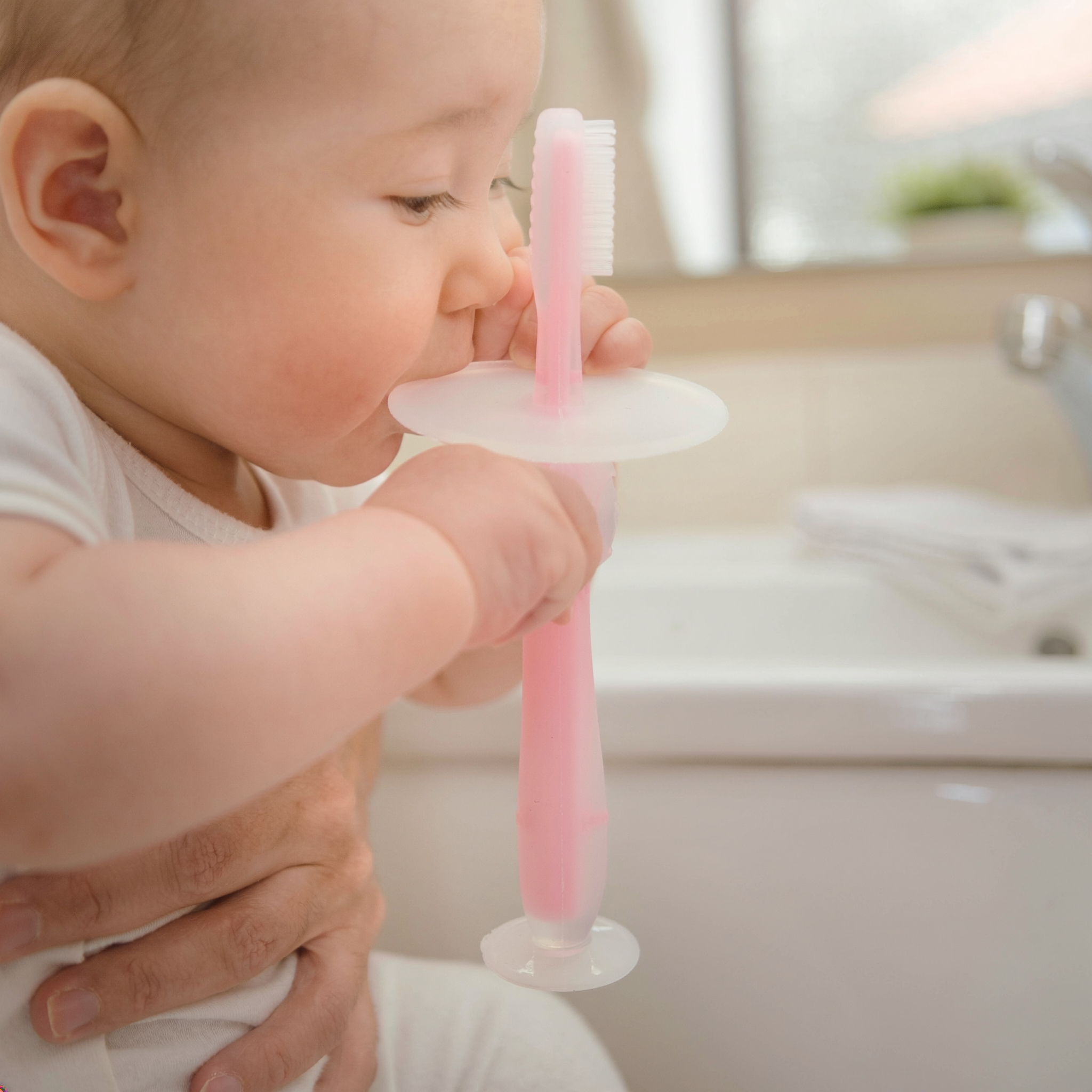 Kids Boon Silicone Infant Training Toothbrush & Teether | Soft Bristles, Anti-Choking Shield & Suction Base (Pink)
