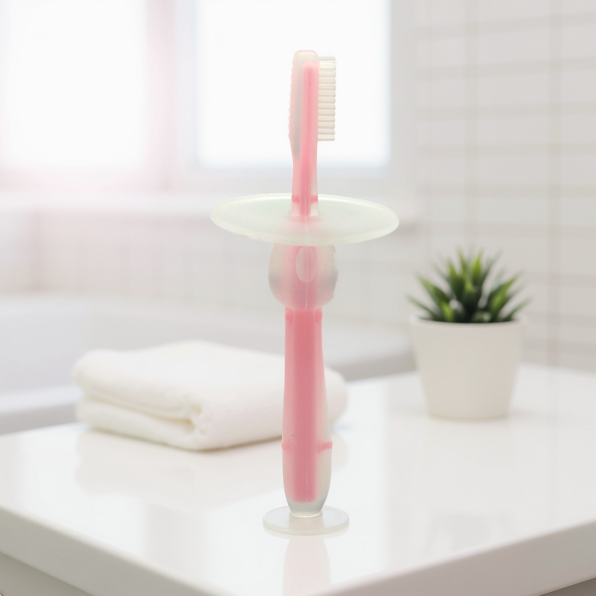 Kids Boon Silicone Infant Training Toothbrush & Teether | Soft Bristles, Anti-Choking Shield & Suction Base (Pink)